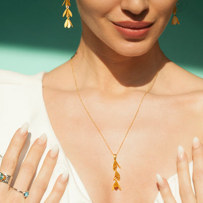 Model Wearing Catkin Flower Pendant Necklace In Gold