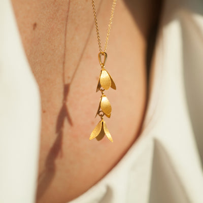 Model Wearing Catkin Flower Pendant Necklace In Gold