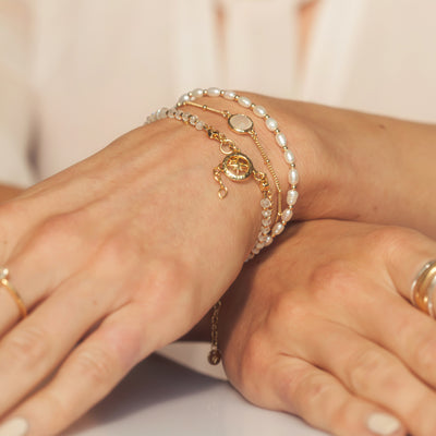 Model Wearing Seed Pearls and Gold Bracelet
