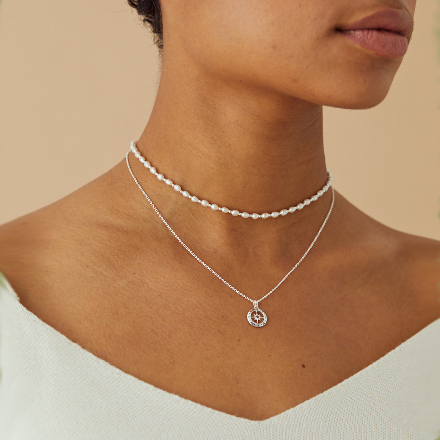 Model Wearing Silver Compass Necklace with December Blue Topaz Birthstone
