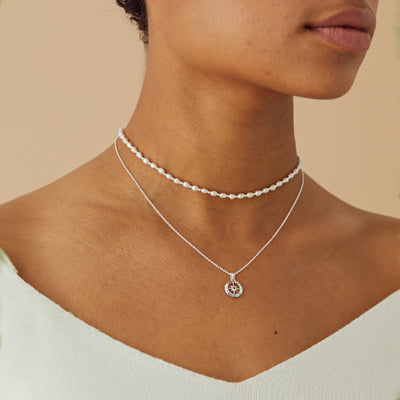 Model Wearing Silver Compass Necklace with January Garnet Birthstone