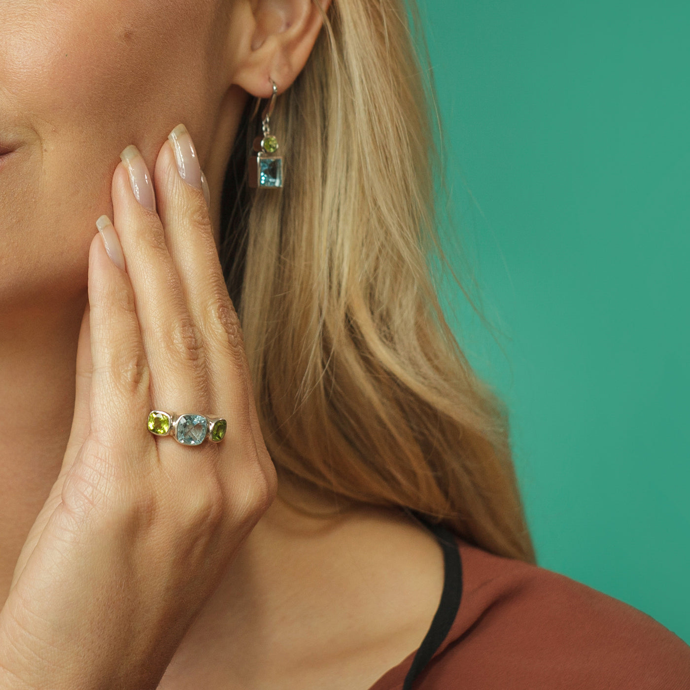 Model Wearing Silver Ring with Blue Topaz and Peridot